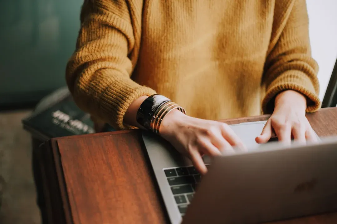 person working remotely on laptop in a comfortable outdoor setting