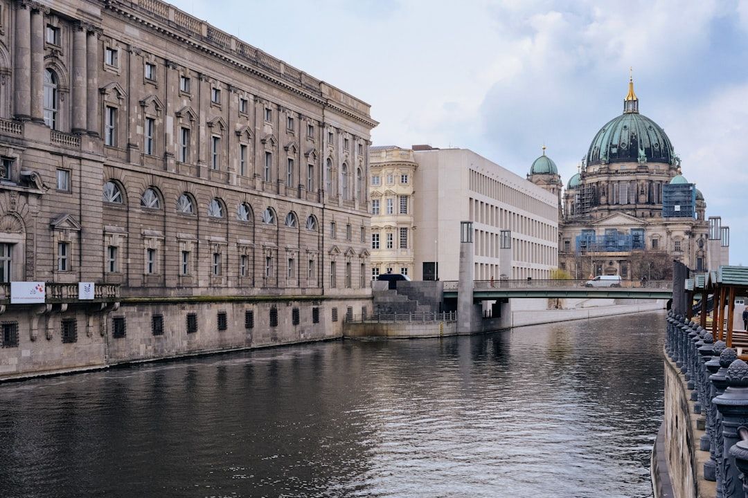 Canal side street in Kreuzberg Berlin with apartment buildings and trees